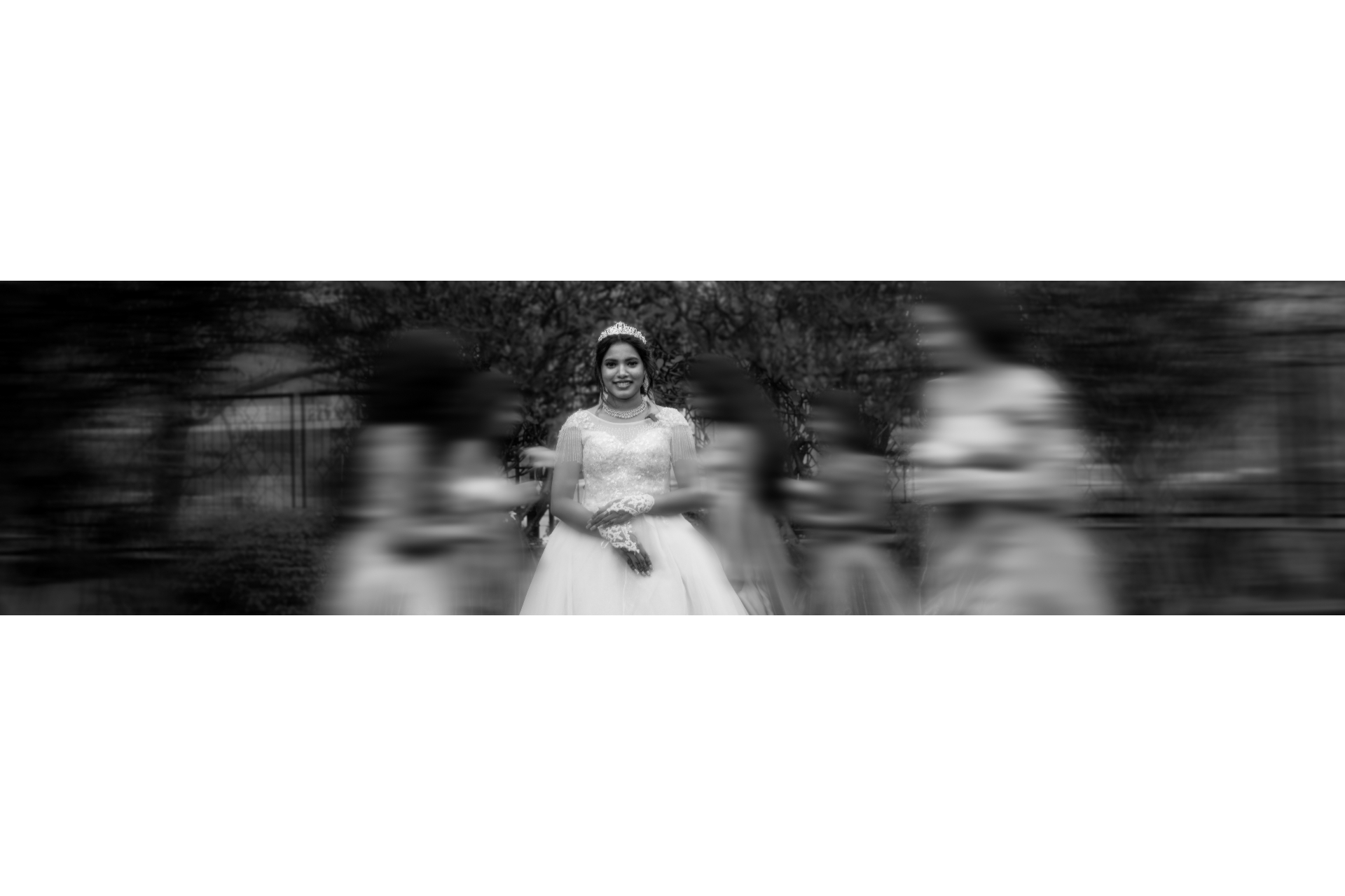 Motion blur portrait of a bride centered as her bridesmaids rush past