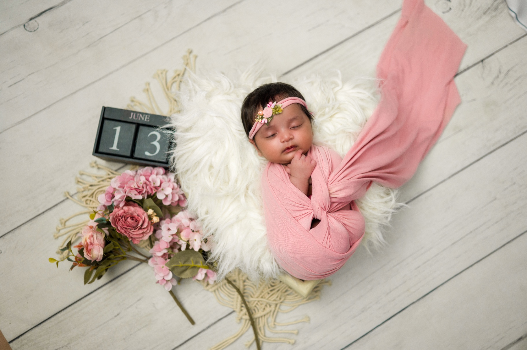 Newborn baby wrapped in pink