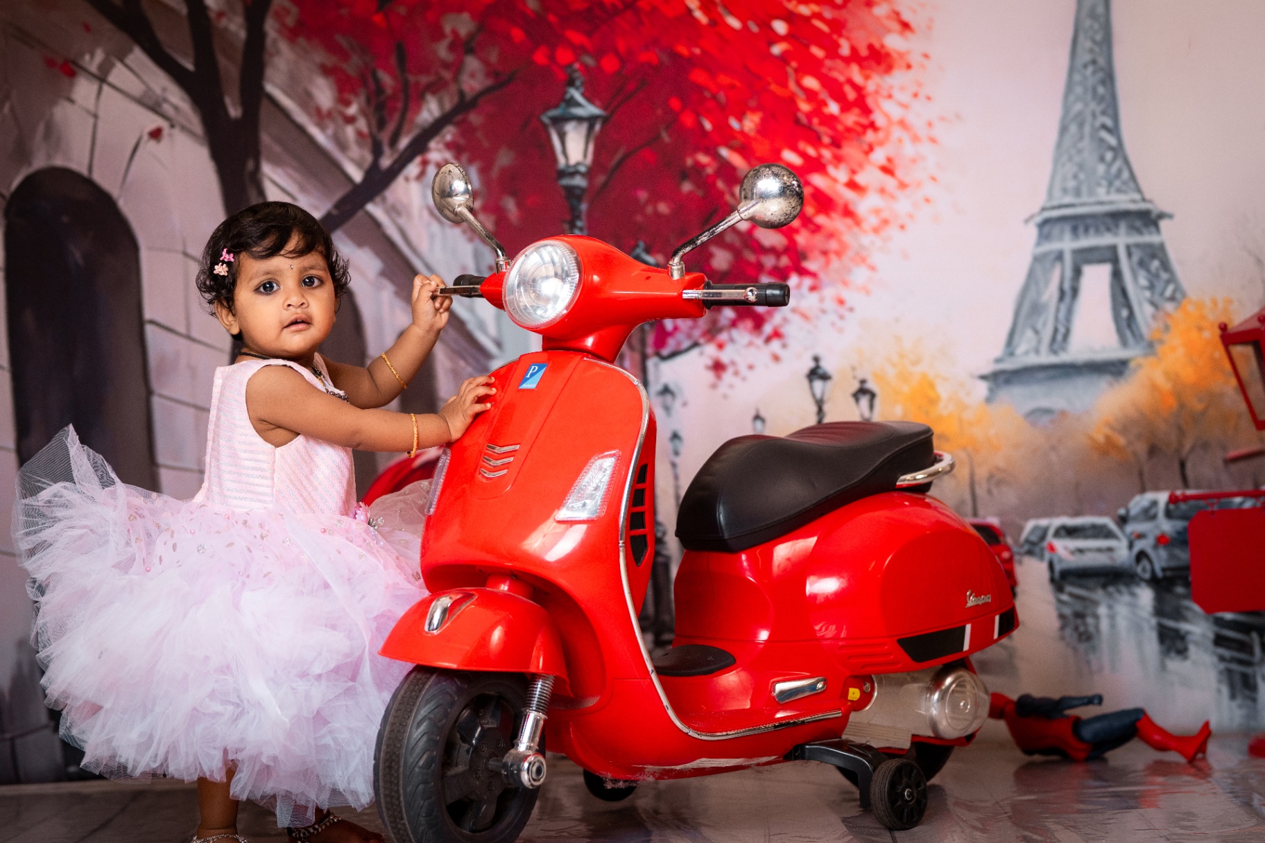 Toddler with red vespa